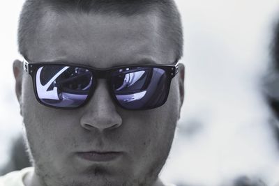 Close-up portrait of young man wearing eyeglasses