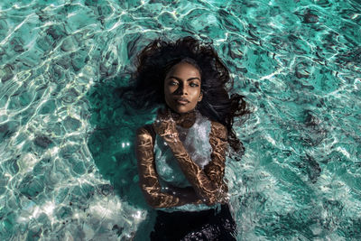 Portrait of young woman in swimming pool