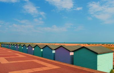 Row of beach huts against sky