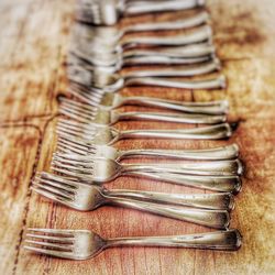 Close-up of forks arranged on table