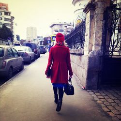 Woman walking on street in city