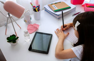 High angle view of woman using laptop on table