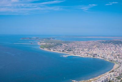 Aerial view of sea and city against sky