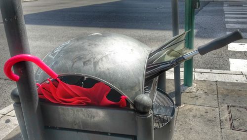 High angle view of red metallic structure on footpath