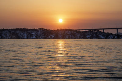 Scenic view of lake against romantic sky at sunset