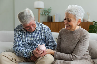 Side view of senior man with dog at home