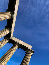 Low angle view of old bridge against blue sky