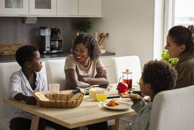 Mothers and sons eating breakfast