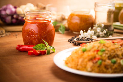 Close-up of food by red chili pepper paste on wooden table