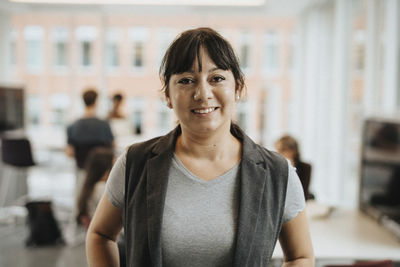 Portrait of smiling female professor in university