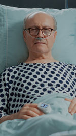 Portrait of man lying down on bed