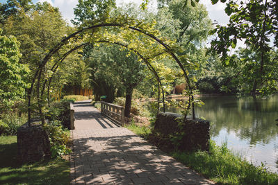 Footpath by lake in park