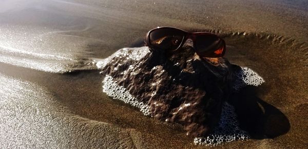 High angle view of a sunglasses on the beach