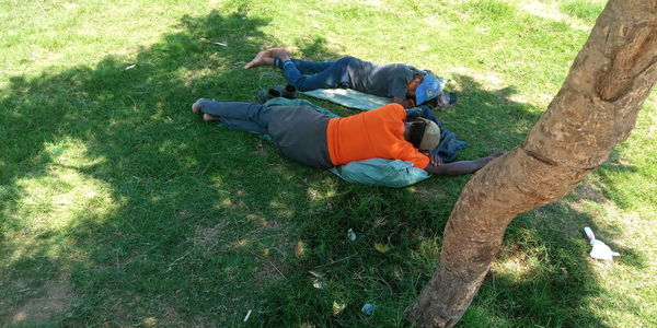 High angle view of men relaxing on field