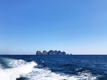 Scenic view of sea against clear blue sky