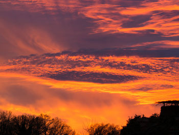 Low angle view of dramatic sky during sunset