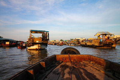 Merchant ship in cai rang floating market against sky 