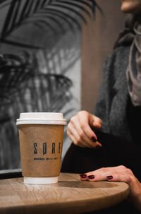 Woman holding coffee cup