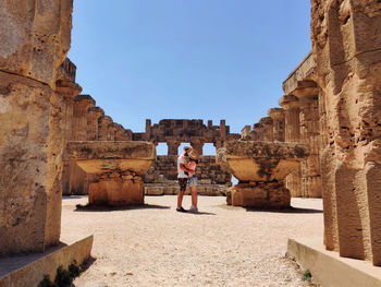 Woman standing in front of historical building