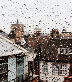 City seen through wet glass window in rainy season