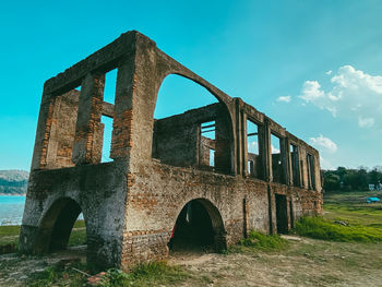 Old arch bridge against sky