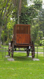 Tractor on field against trees in forest
