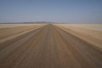 Scenic view of empty road against clear sky