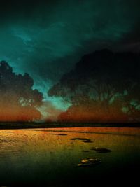 Scenic view of lake against sky at night