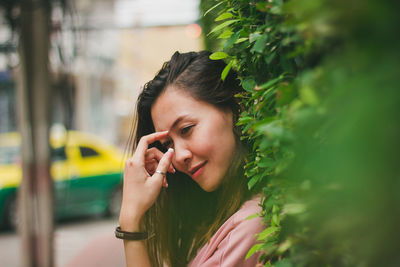 Portrait of young woman using mobile phone outdoors