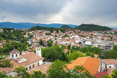 High angle view of houses in town against sky