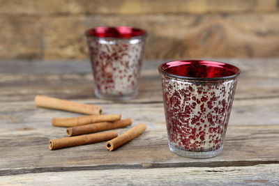 Cinnamons with tea light candles on wooden table