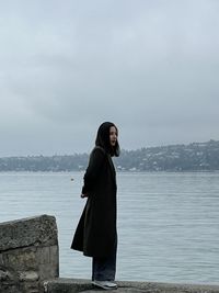 Low angle view of man jumping against sky