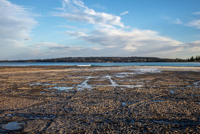 Scenic view of beach against sky during winter