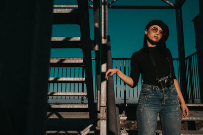 Young woman standing on staircase