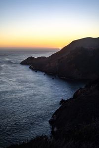 Scenic view of sea against clear sky during sunset