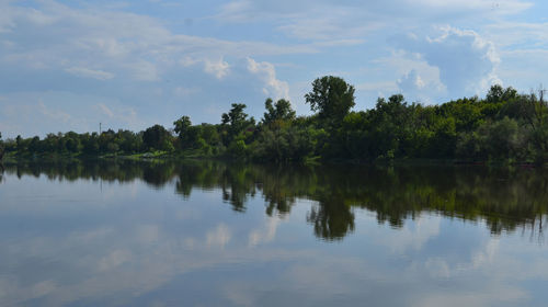 Reflection of trees in lake against sky