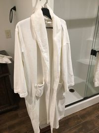 Bathrobe hanging in coathanger at home