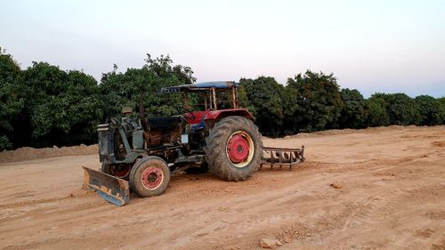 Tractor on field against sky