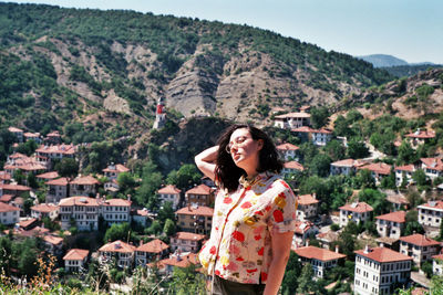 Beautiful woman posing in front of city view