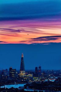 Aerial view of city lit up at sunset