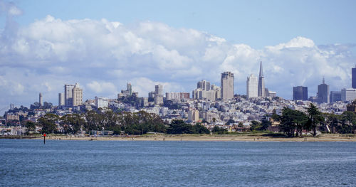 Panoramic view of sea and buildings against sky