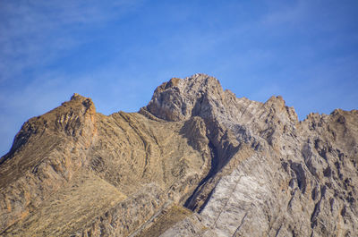 Scenic view of rocky mountains against blue sky