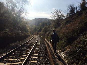 Rear view of man on railroad track