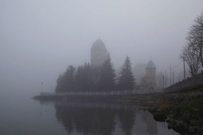 Panoramic view of lake and buildings against sky