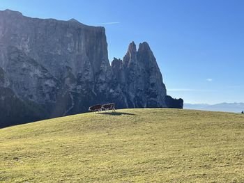 Rock formations on field against sky