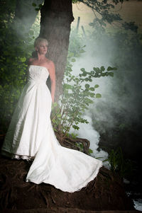 Young woman standing on white tree