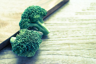 Close-up of broccolis on cutting board in kitchen