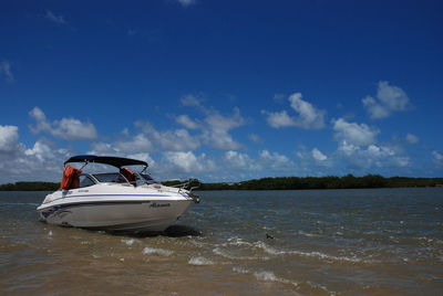 Boat on calm sea against sky