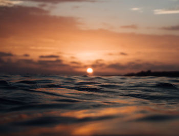 Scenic view of sea against romantic sky at sunset