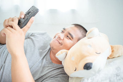 Portrait of man relaxing on bed at home